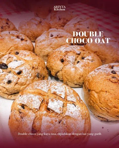 Double Choco Oat bread loaves on a gingham cloth, with the Arinta Kitchen logo